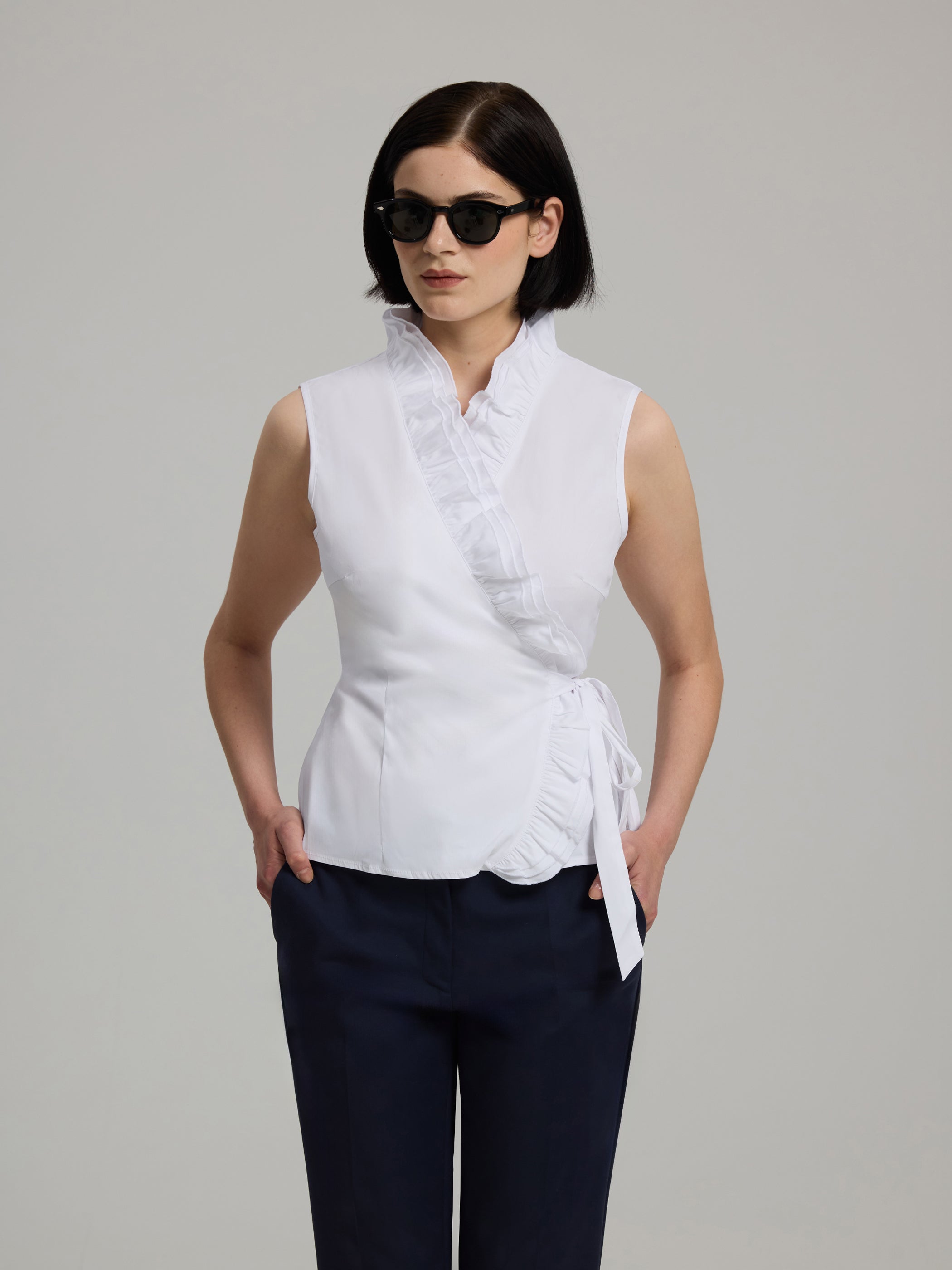 Dorita White Sleeveless Wrap Top with Ruffled Neckline – Andiata